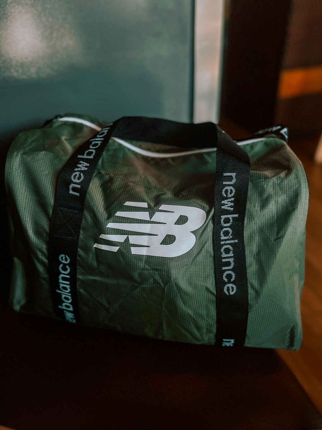 a green bag sitting on top of a wooden table