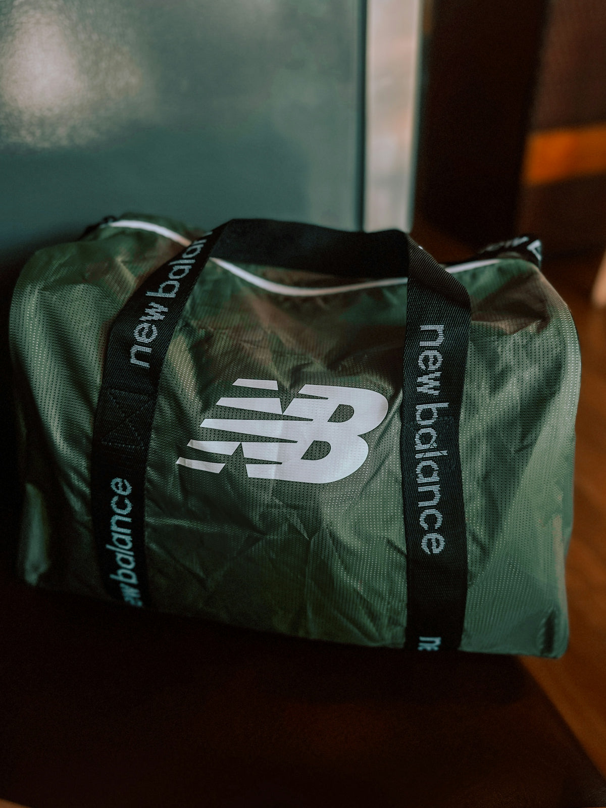a green bag sitting on top of a wooden table